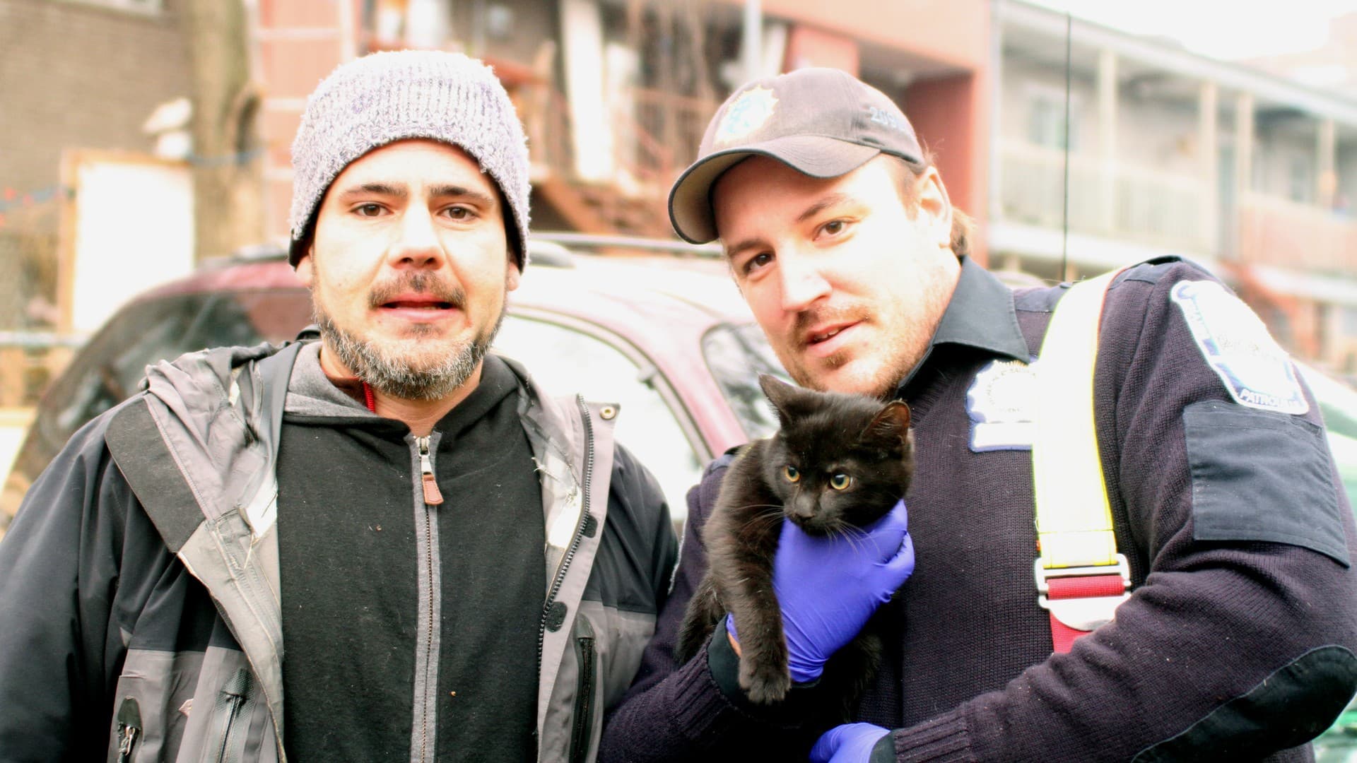 Eric Dussault remettant un chaton noir à un citoyen
